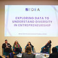 four speakers during a panel discussion with a slide entitled 'Exploring data to understand diversity in entrepreneurship' behind them on the wall