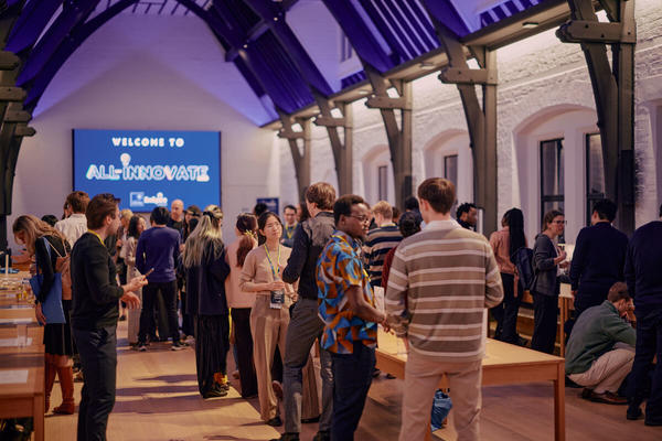 A group of people networking at an event at Reuben College, Oxford