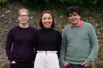 beautiful voice team - two women and one man standing together