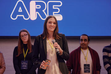A student pitching at a startup competition event