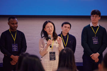 A student pitching at a startup competition event