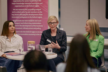 Three panellists in deep discussion during an event