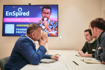 Industry experts sat at a table with aspiring founders giving advice