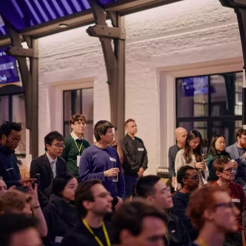 Attendees at a startup event sitting in the audience watching pitches