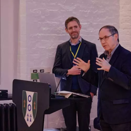 A speaker at a podium addressing the audience at a startup event