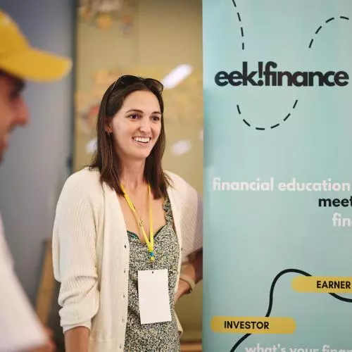 a startup founder smiling at their stand