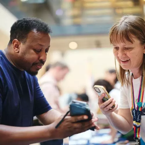 event attendees looking at their phones and smiling