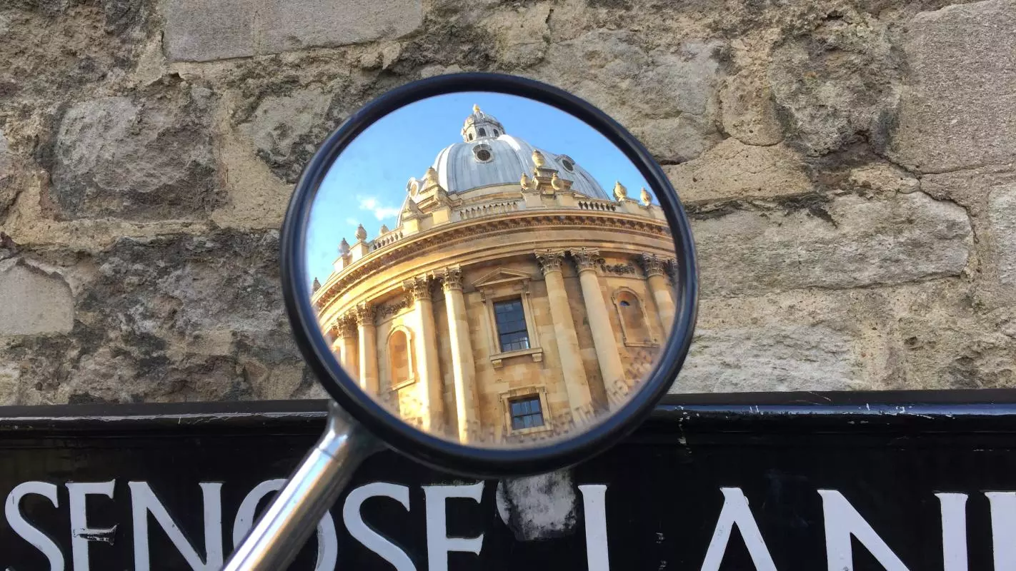 RADCLIFFE CAMERA REFLECTED IN A MIRROR ON BRASENOSE LANE