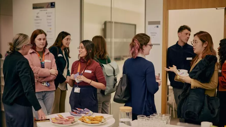 A group of event attendees networking over drinks