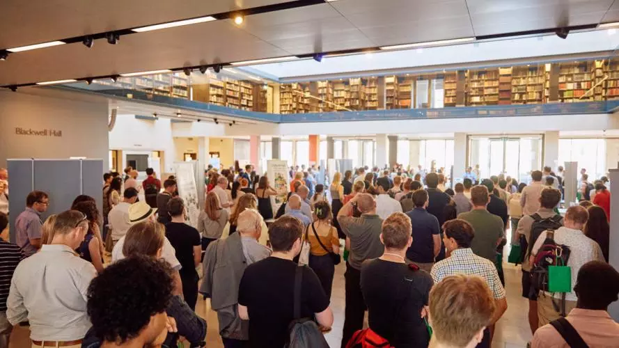 A crowd at an event listening to a speaker