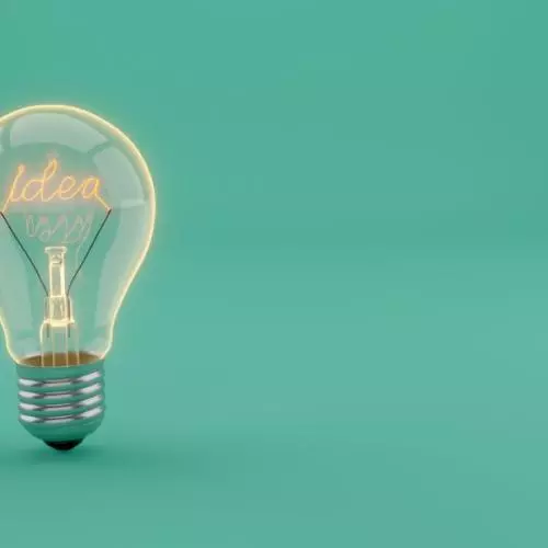 A lightbulb on a plain blue background with the word 'idea' spelt out as filament
