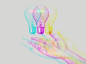 A hand outstretched with a lightbulb hovering over it with a trippy design